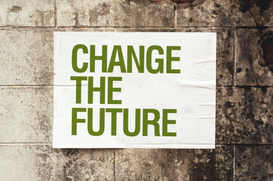 Change the Future poster on grunge wal. Conceptual image.